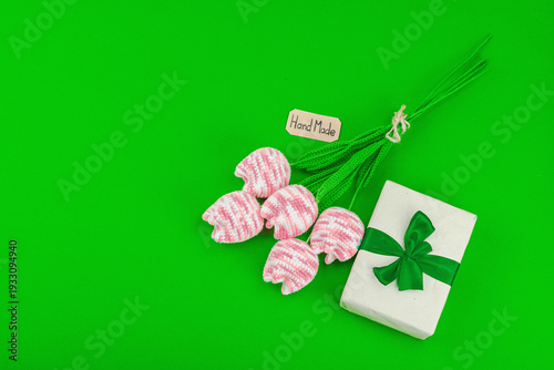 Handmade crochet tulip bouquet with wrapped gift box. Creative spring holiday present, artisan craft