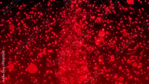 Vibrant red particles explode in dynamic motion against dark background