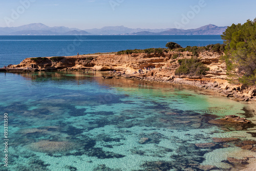 Scenic view of Playa Es Calo in Arta Mallorca with crystal clear turquoise water and rocky coastline