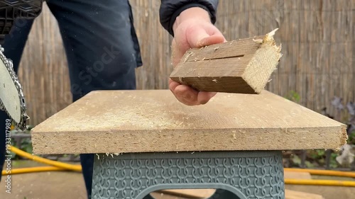 Hands holding rough cut lumber over outdoor workbench, backyard woodworking and DIY carpentry project, practical home improvement mood, Fathers Day maker gift idea