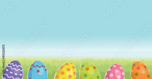 Easter banner. Colored eggs hang on strings and lie hidden in the grass. Happy Easter.