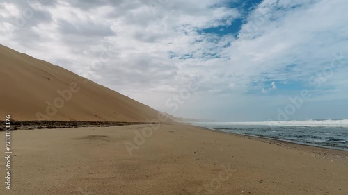 Sandwich Harbour in Namibia at the coast of the Atlantic Ocean. Sandy beach. Sandwich Harbor roundtrip daytime car tour