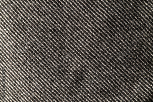Herringbone wool textile close-up — moody gray tweed texture, soft woolen fibers, ideal seamless background for fashion and product layouts.