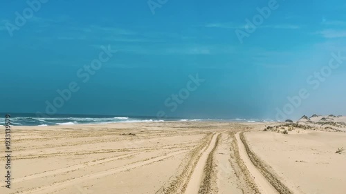 Sandwich Harbour in Namibia at the coast of the Atlantic Ocean. Sandy beach. Sandwich Harbor roundtrip daytime car tour