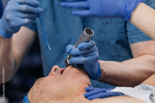 Photography Clinical staff inserting endotracheal tube to induce anesthesia in patient before surgery