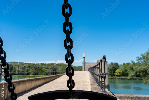 Vászonkép Metal chains framing the historic pont saint-bénézet bridge over the rhone river