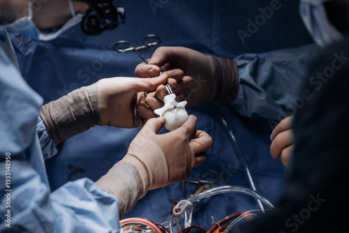 Skilled surgeons performing complex heart valve replacement under surgical lighting. Patient care concept.
