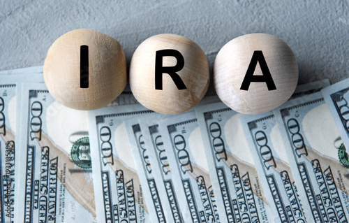 IRA - acronym on wooden balls on the background of banknotes