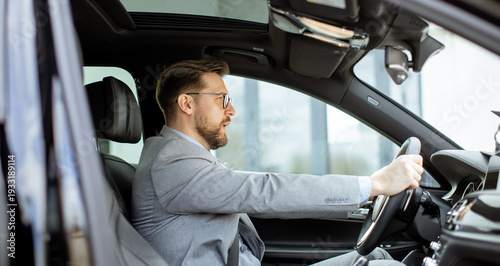 Businessman drives luxury c...