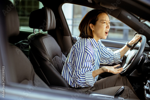 Korean woman sits in car an...