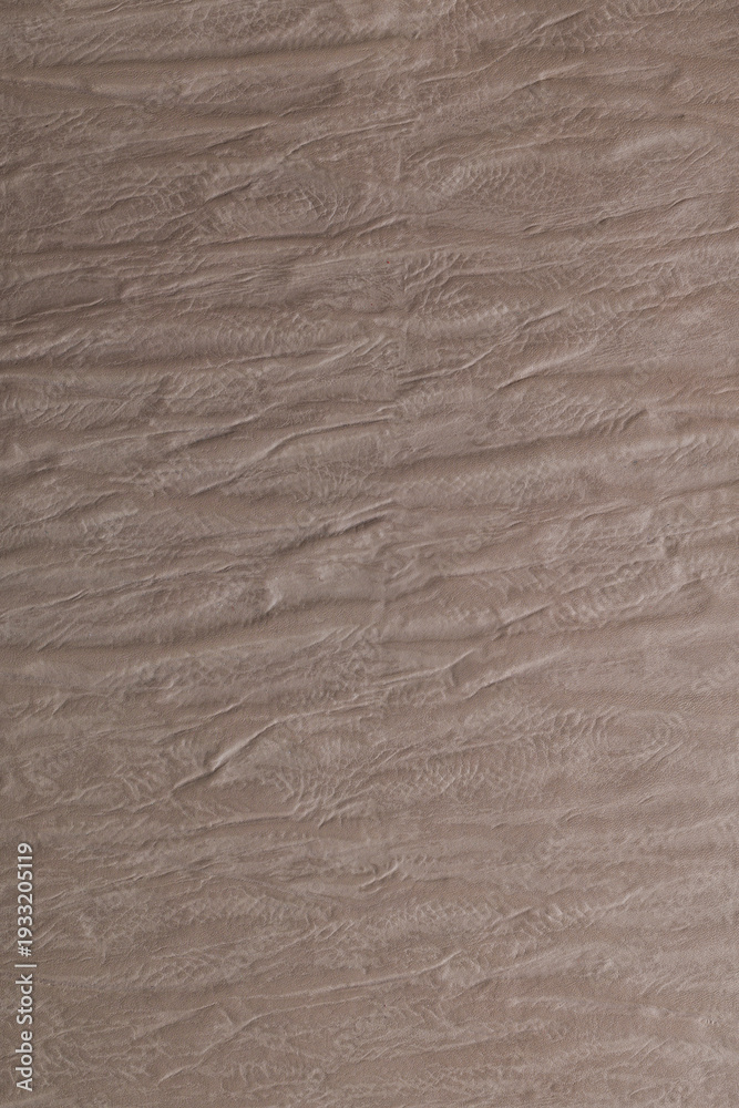 Obraz premium Texture of a wooden surface seen in a close-up as light creates shadows on the grooves of the wood during daytime
