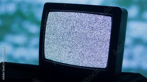 Retro TV, vintage television In a nostalgic setup, a retro TV displays grain on screen, scary halloween night device good for chroma key and green screen.