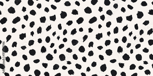 Abstract black spots on a cream colored background resembling animal print