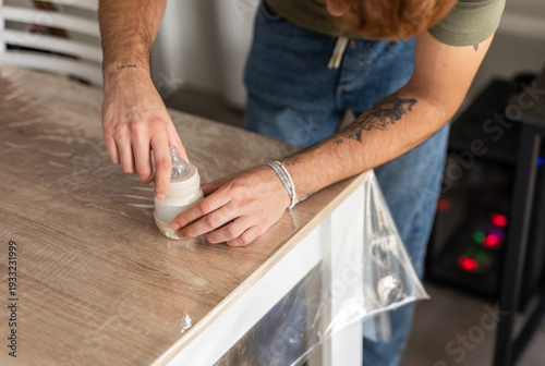a man preparing a baby bottle