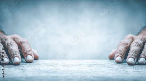 Elderly hands resting on concrete emphasizing aging skin
