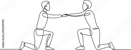 Two men engaging in a fierce arm wrestling match on the floor, a test of strength and endurance