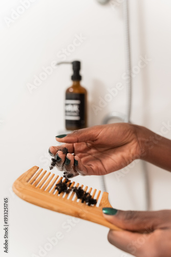 Woman collecting broken hair from comb