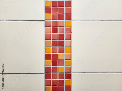 On the tiled wall, there is a pattern of small red tiles