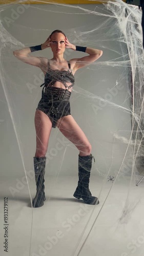 Gothic Model Posing in Spiderweb for Fashion Shoot