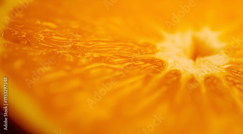Close-up of a fresh orange slice with vibrant textures and rich orange hues.