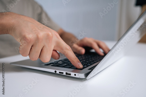 Schilderij op canvas Person finger pressing laptop power button, turning on or off portable computer,