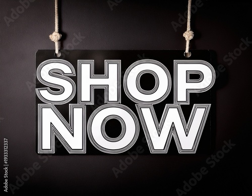 a black and white hanging sign with the words shop now in bold white letters against a solid black background perfect for retail promotions