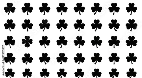 Pattern of black shamrocks on a simple background viewed from directly above