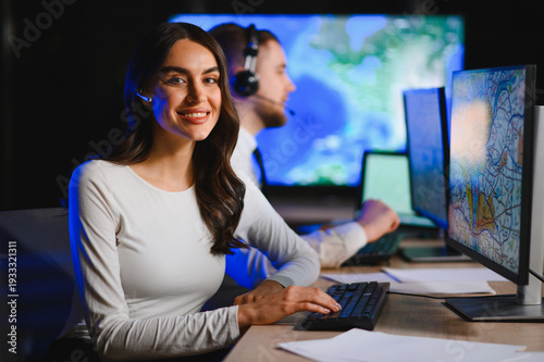 Woman working in logistics dispatch center smiling