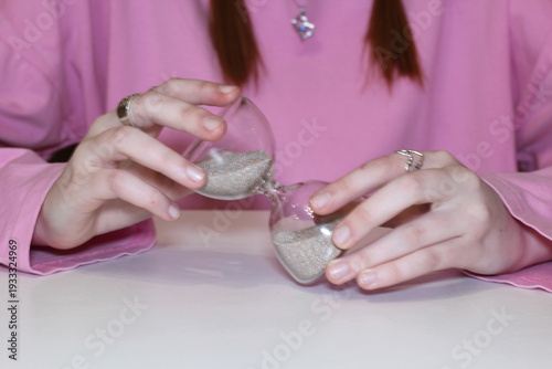 Wallpaper Mural Female hands and hourglass on the table symbol of passing time concept photo Torontodigital.ca