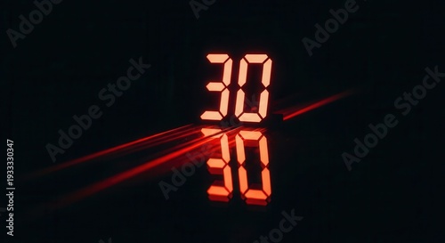 Digital Display Showing Number Thirty with Reflection and Red Light Streaks on Dark Background