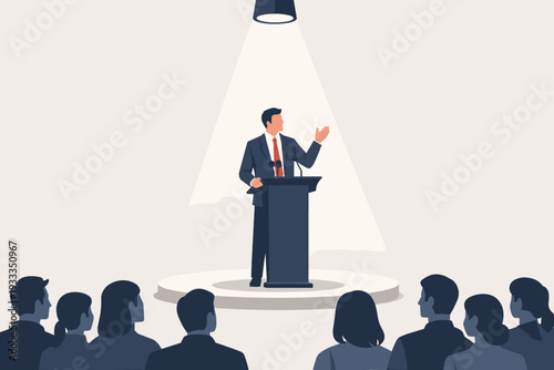 Businessman Giving a Motivational Speech on Stage Under a Spotlight to an Audience, Public Speaking and Leadership Concept, Successful Orator Presenting Business Strategy at a Conference Seminar