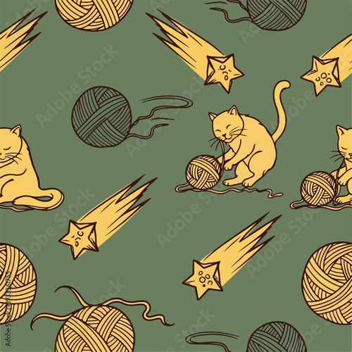 Cute yellow cats playing with balls of yarn and shooting stars seamless pattern on a green background