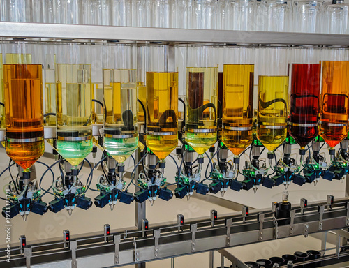 Perfume production. Different scents in bottles. Robotic perfume production line with automated fragrance dispensing 