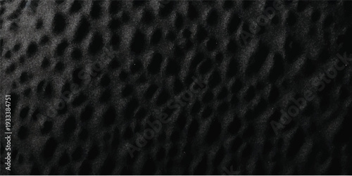 Seamless black and white macro leopard skin texture featuring a natural animal fur pattern on a dark textured surface for a rough material backdrop