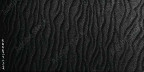 A macro surface shot of a rough black leather texture background featuring a natural skin pattern with ripples and waves that resemble a dark desert sand dune