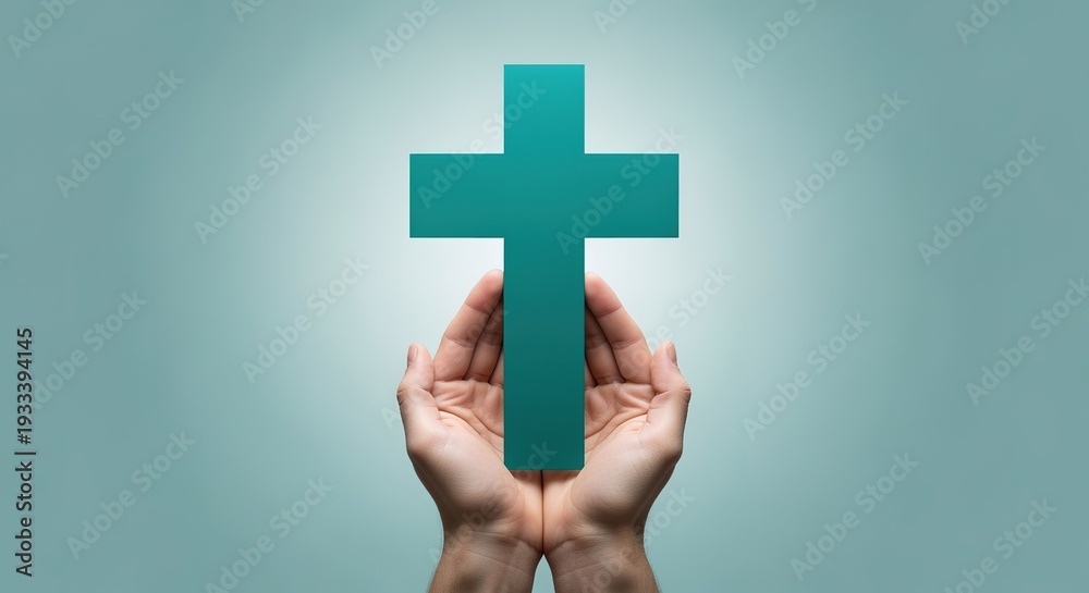Obraz premium Person holding a teal cross in their hands symbolizing faith and spirituality in a serene and calming environment with a soothing light blue background