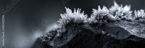 Close-up View of Frost Crystals on Dark Obsidian Rock With Bokeh Background and Moody Atmosphere in Macro Detail