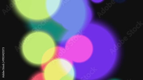 Vibrant multicolored bokeh lights on black background.