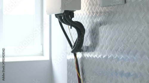 Home solar battery storage module with power cables and connectors.