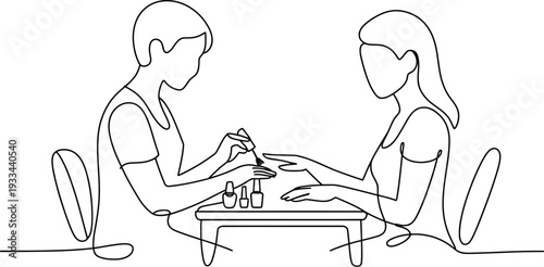 Person applying nail polish to another person's hand on a table.
