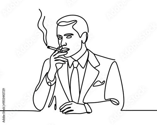 A man in a suit sitting at a table smoking a cigarette