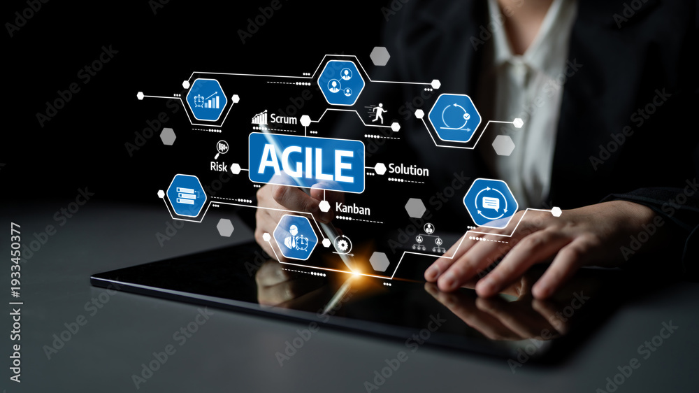 Fototapeta premium A close-up view of a business professional interacting with a tablet, featuring agile project management graphics, illustrating concepts like scrum and kanban in a modern workspace. Tessel