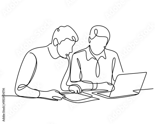 Two businessmen working together on a laptop and tablet in a meeting