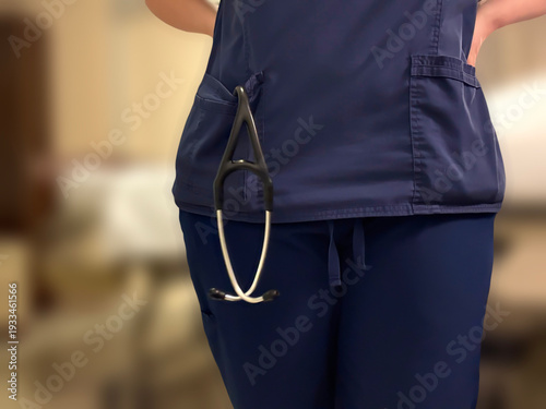 Cuadro en lienzo Faceless Nurse Standing at Hospital Bedside with Stethoscope in Scrubs Pocket He