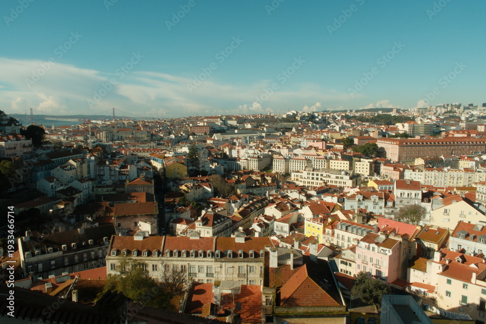 Obraz premium Beautiful red roof tops of portuguese buildings in lisbon on a sunny day with blue sky