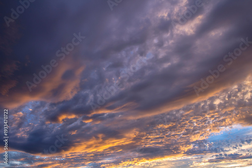Dramatic beautiful sky background with clouds. Bottom-up view. Nature concept for design or for adding text. Abstract background with a natural sky. Close-up.
