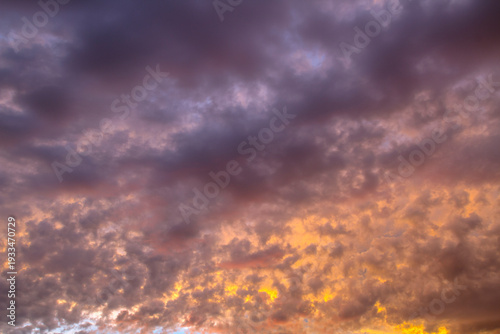 Dramatic beautiful sky background with clouds. Bottom-up view. Nature concept for design or for adding text. Abstract background with a natural sky. Close-up.