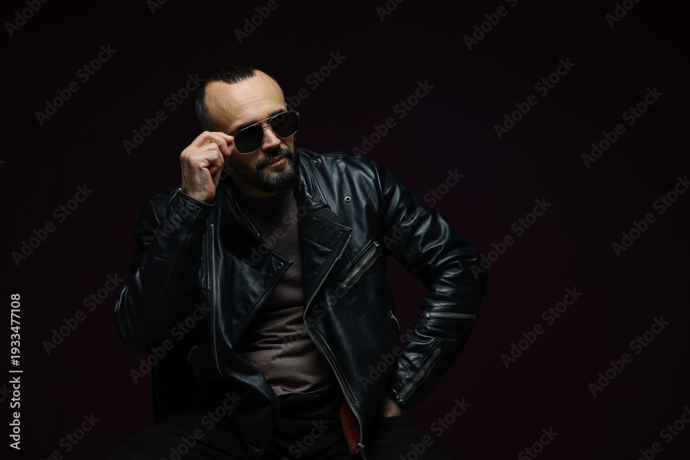 Obraz premium Fashion model. Handsome man in sunglasses on black background, space for text