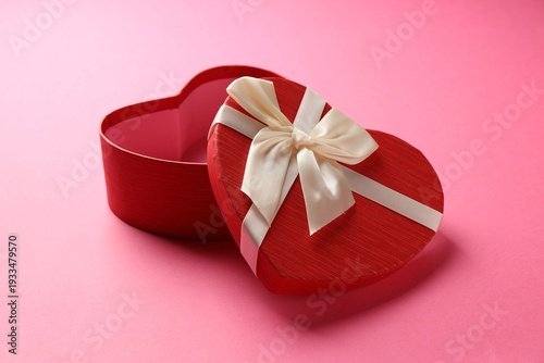 Beautiful heart shaped box on pink background, closeup