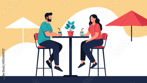 Happy couple enjoys drinks and conversation while sitting at a high table in an outdoor cafe on a sunny day under colorful umbrellas.